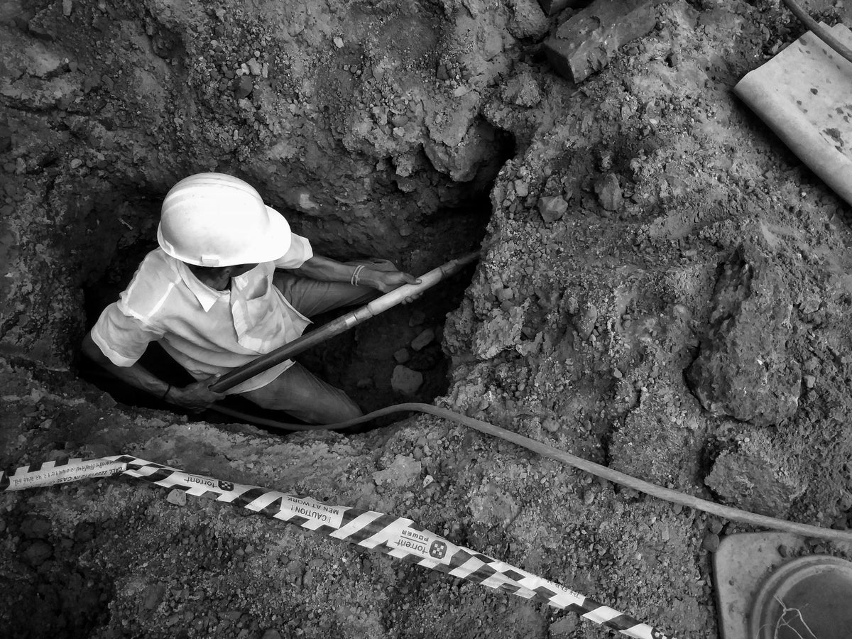 miner digging to extract raw tungsten ore