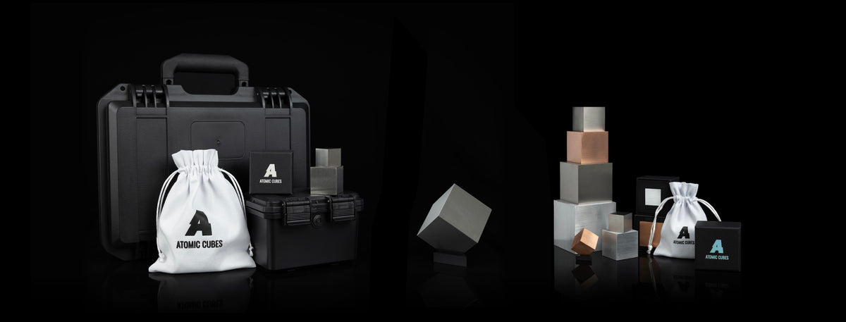 A selection of precision-machined metal cubes in different elements arranged together for comparison.