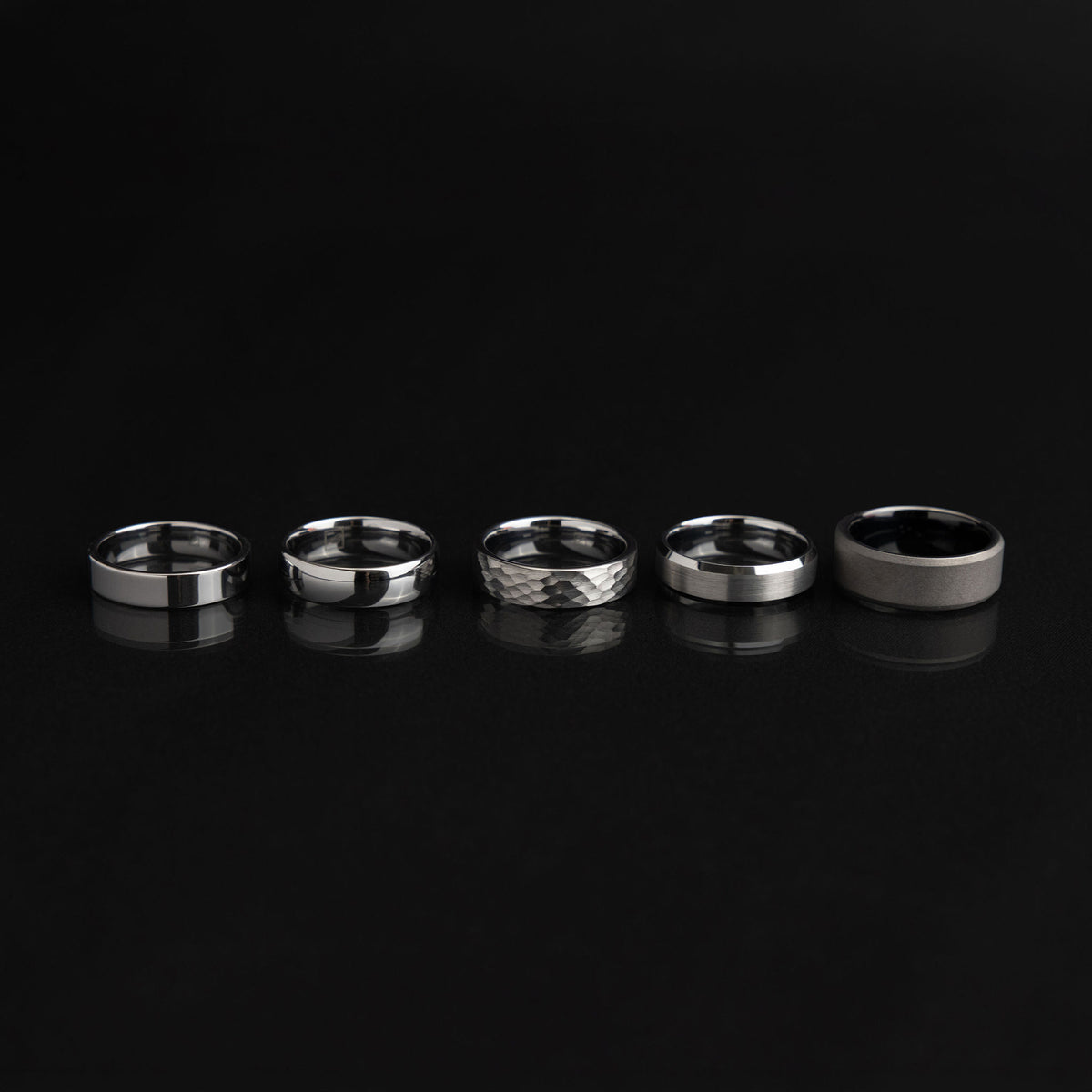 A selection of tungsten and titanium rings showing different profiles, widths, colours and surface finishes.