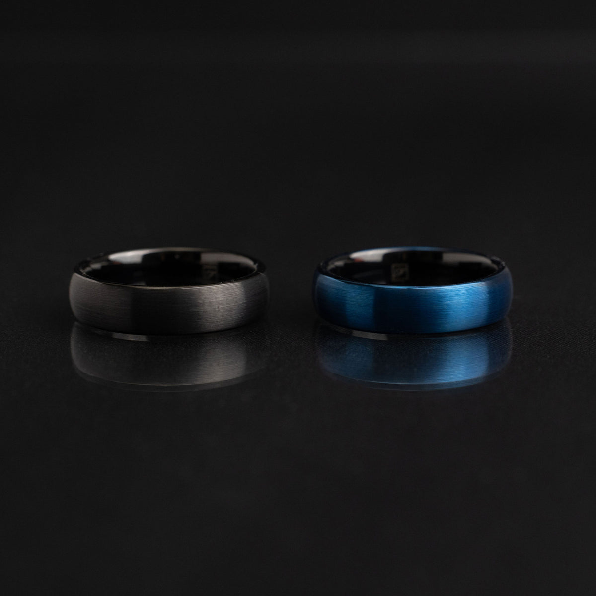 A brushed tungsten ring photographed close-up to show its fine matte texture and coloured finish.