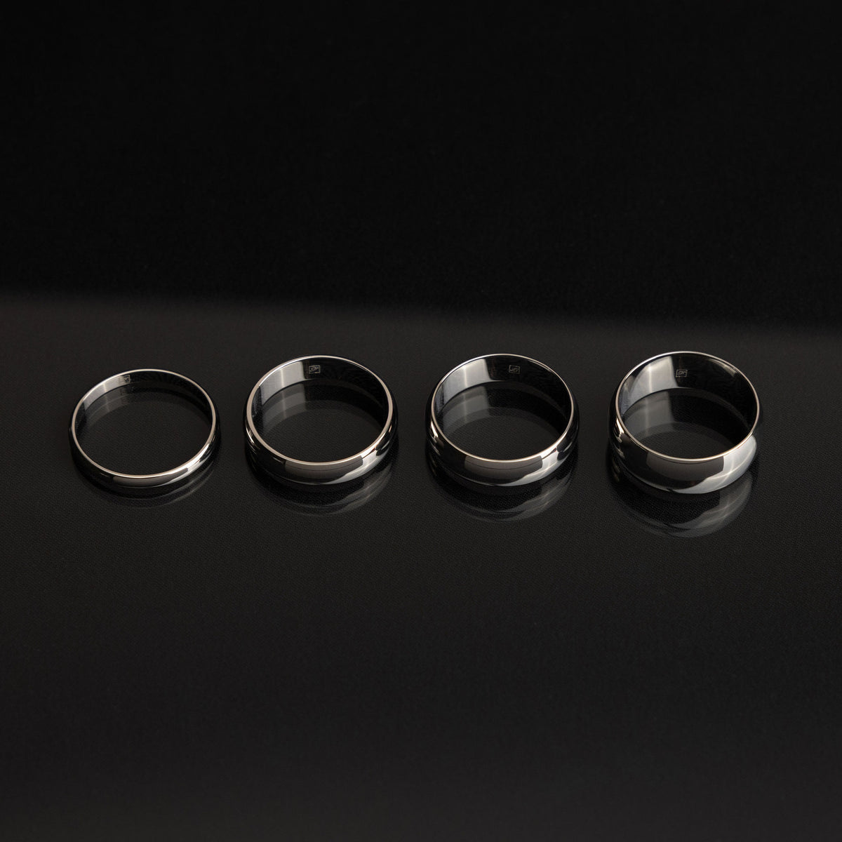 A D shape ring photographed from an angle that clearly shows its domed outer surface and clean profile.