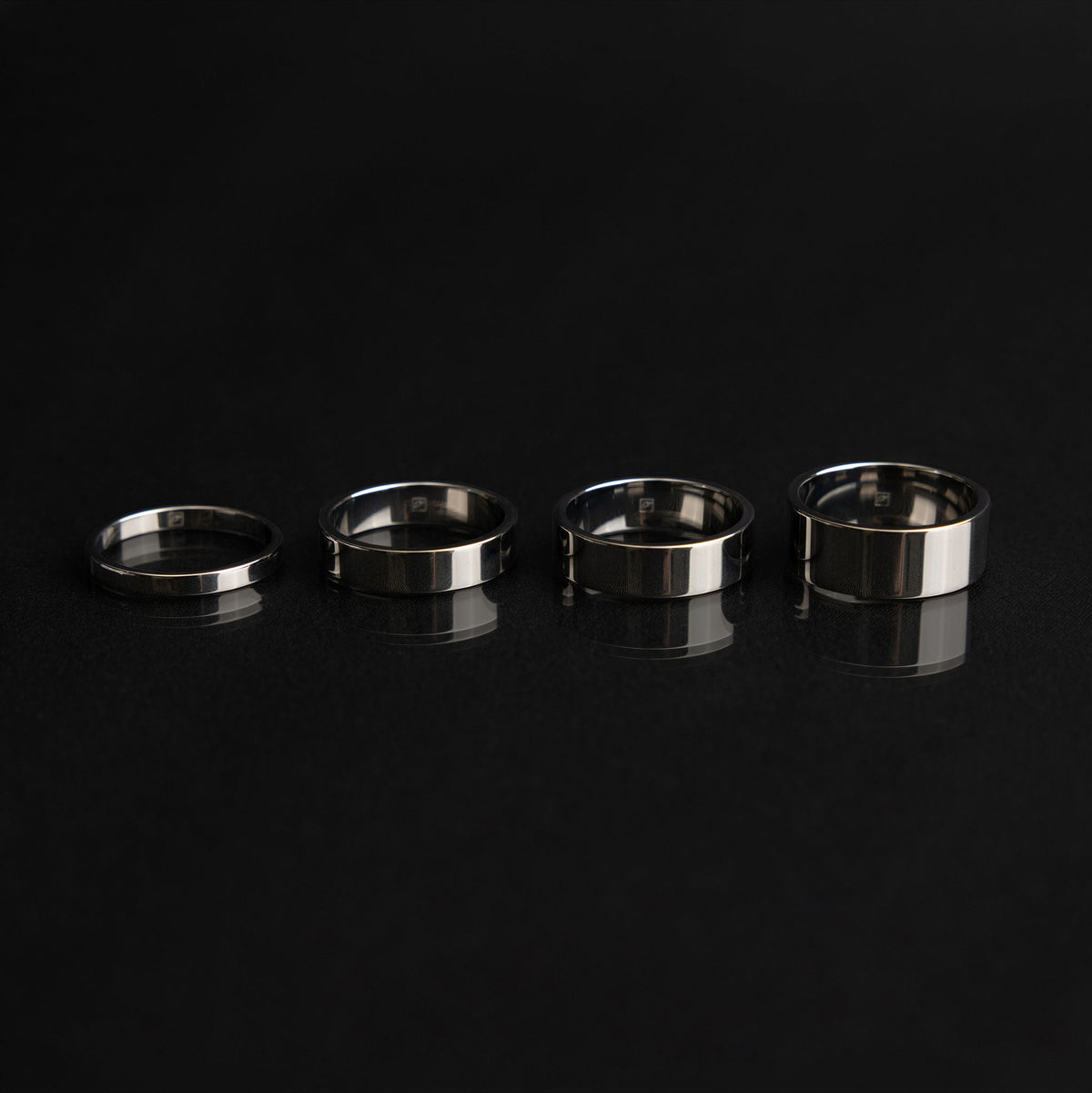 A flat court ring photographed to show its straight outer surface and rounded inner profile.